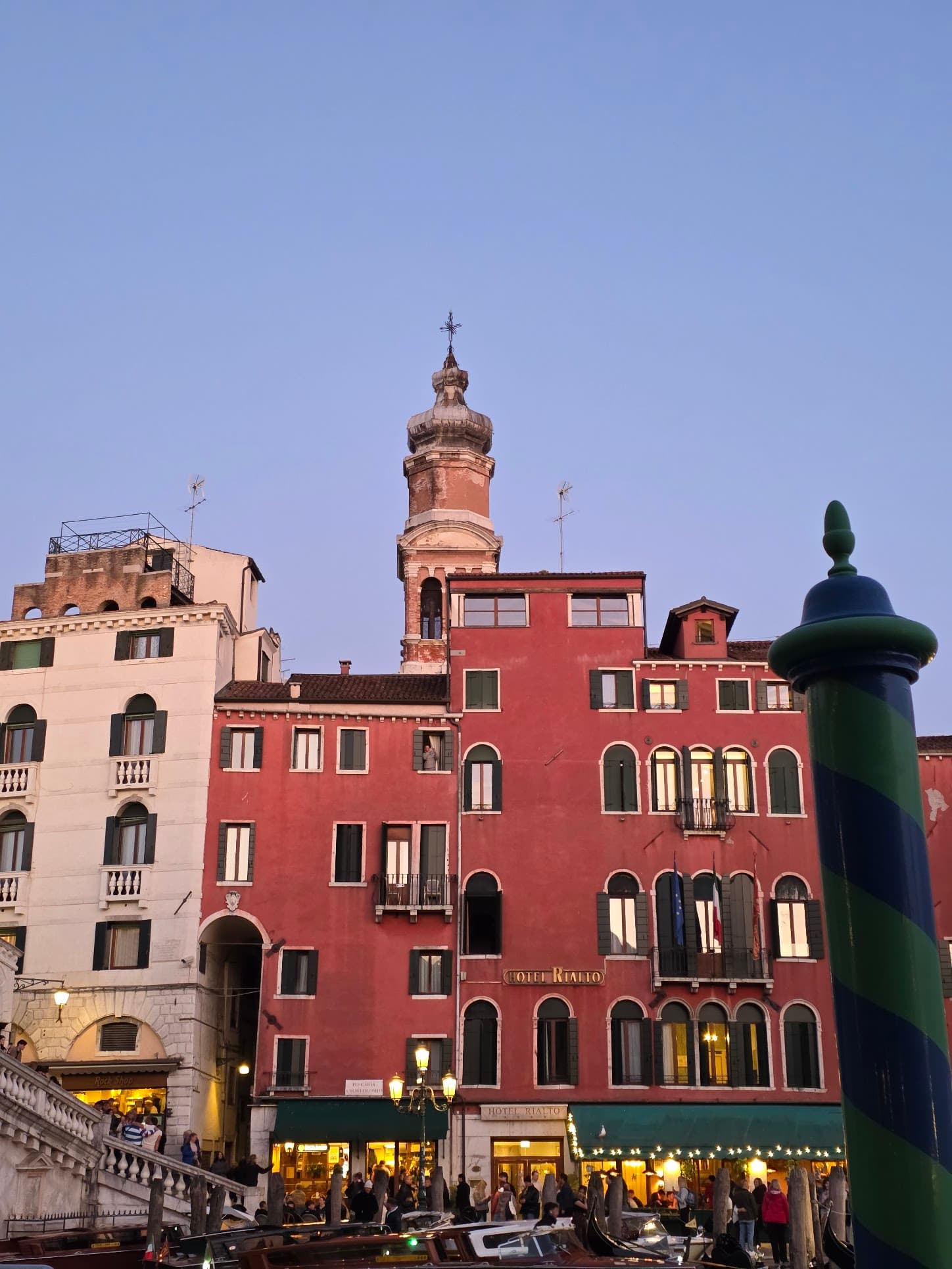 A striking red Renaissance building in Venice at golden hour