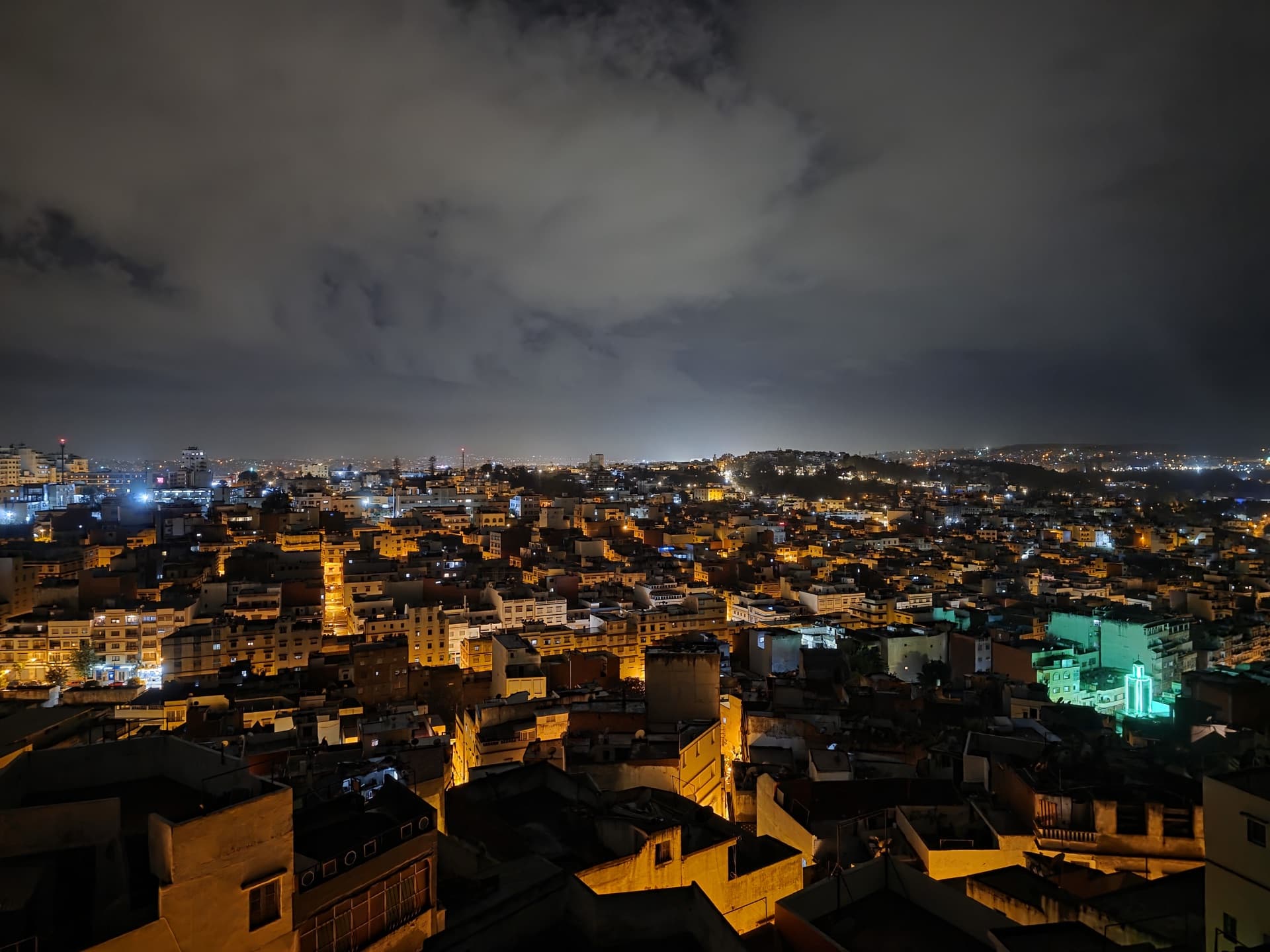 Tangier rooftops at dusk, a cascading sea of warmly lit mud-brick buildings